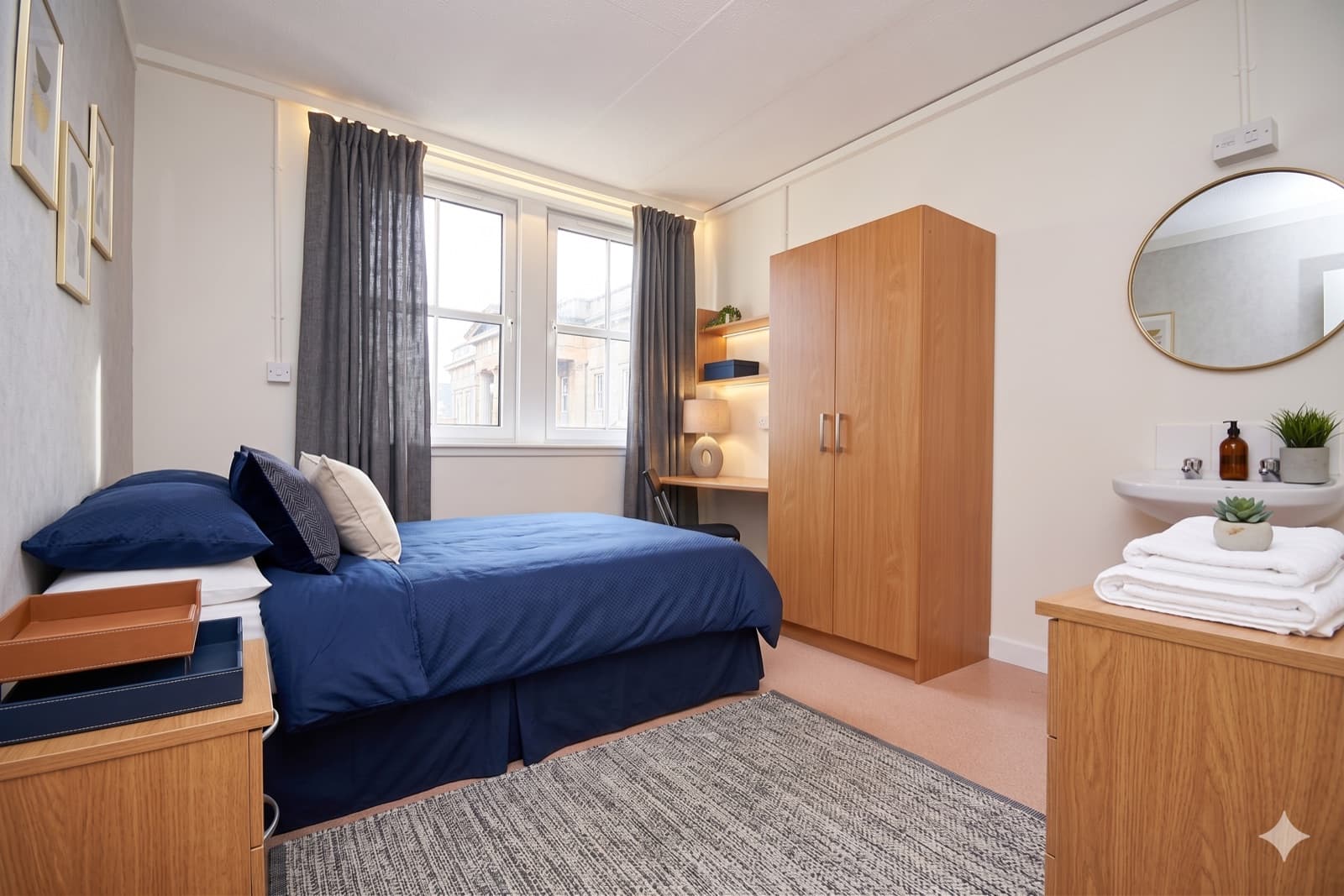 A private double room at Ocean Hostel: double bed, desk, wardrobe and washbasin.